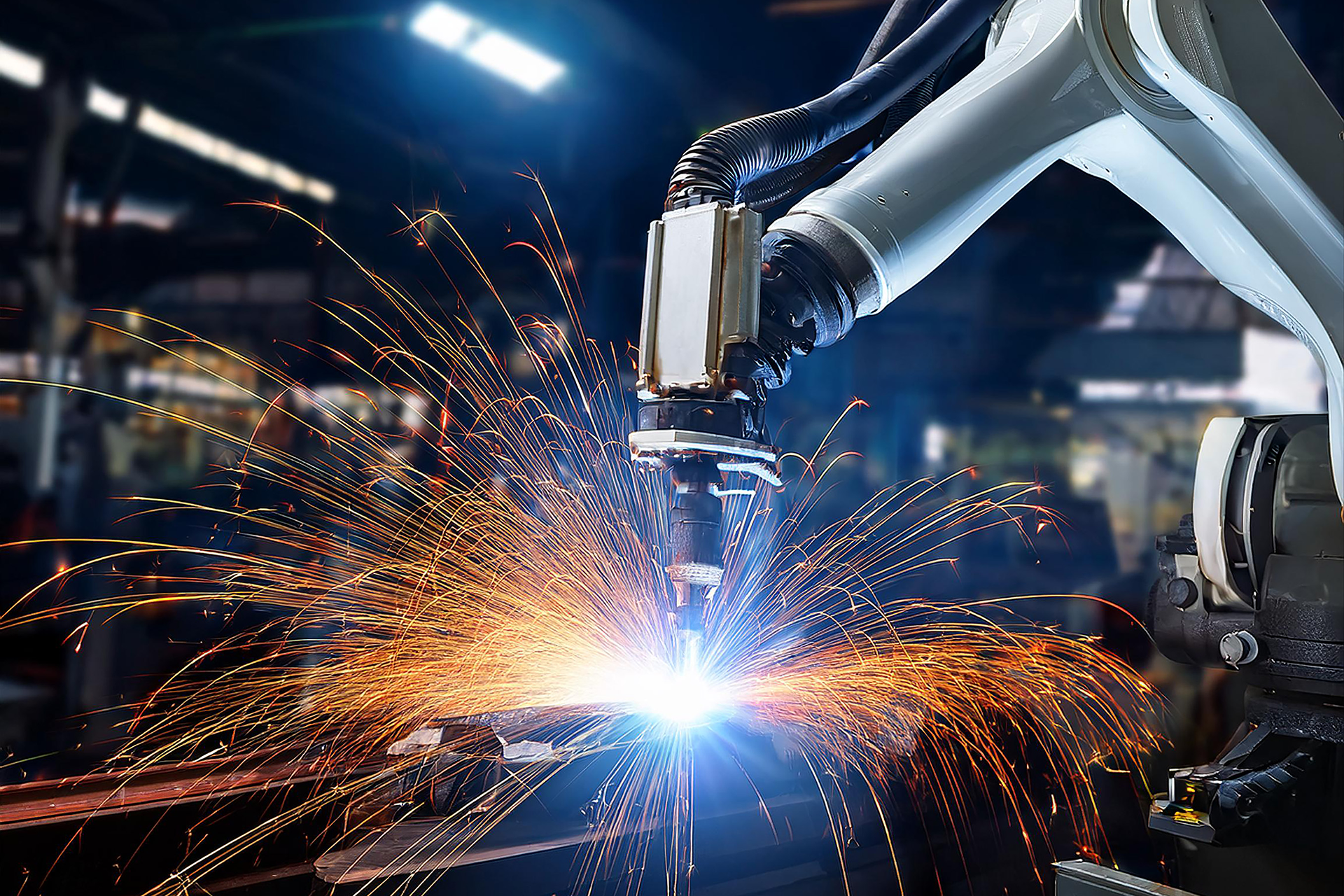 Robot arm welding metal modern factory setting night